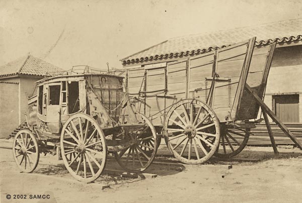 Photographic print of a stagecoach and prairie schooner on display at Sutter